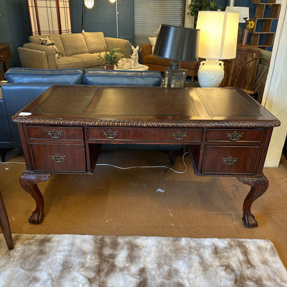 Wooden desk with drawers in a room with furniture and decor