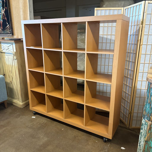 Wooden bookshelf with geometric design in a room setting