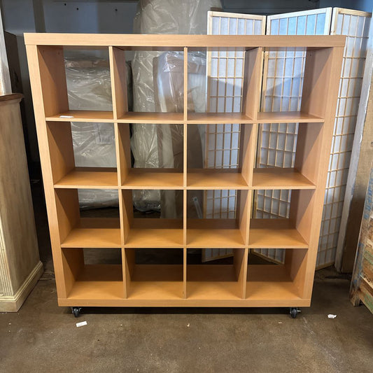Wooden bookshelf with multiple shelves in a room setting