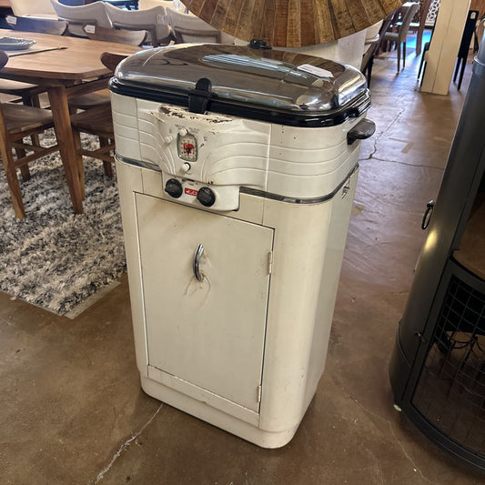 Vintage-style cooler with a metallic top in an indoor setting