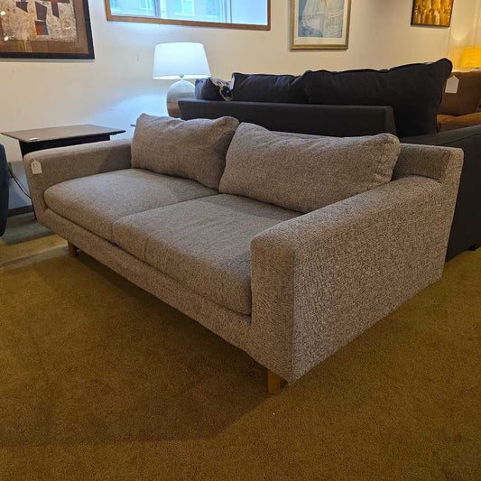Gray sofa with cushions in a living room setting