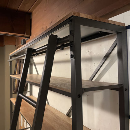 Wooden table with metal frame against a white wall