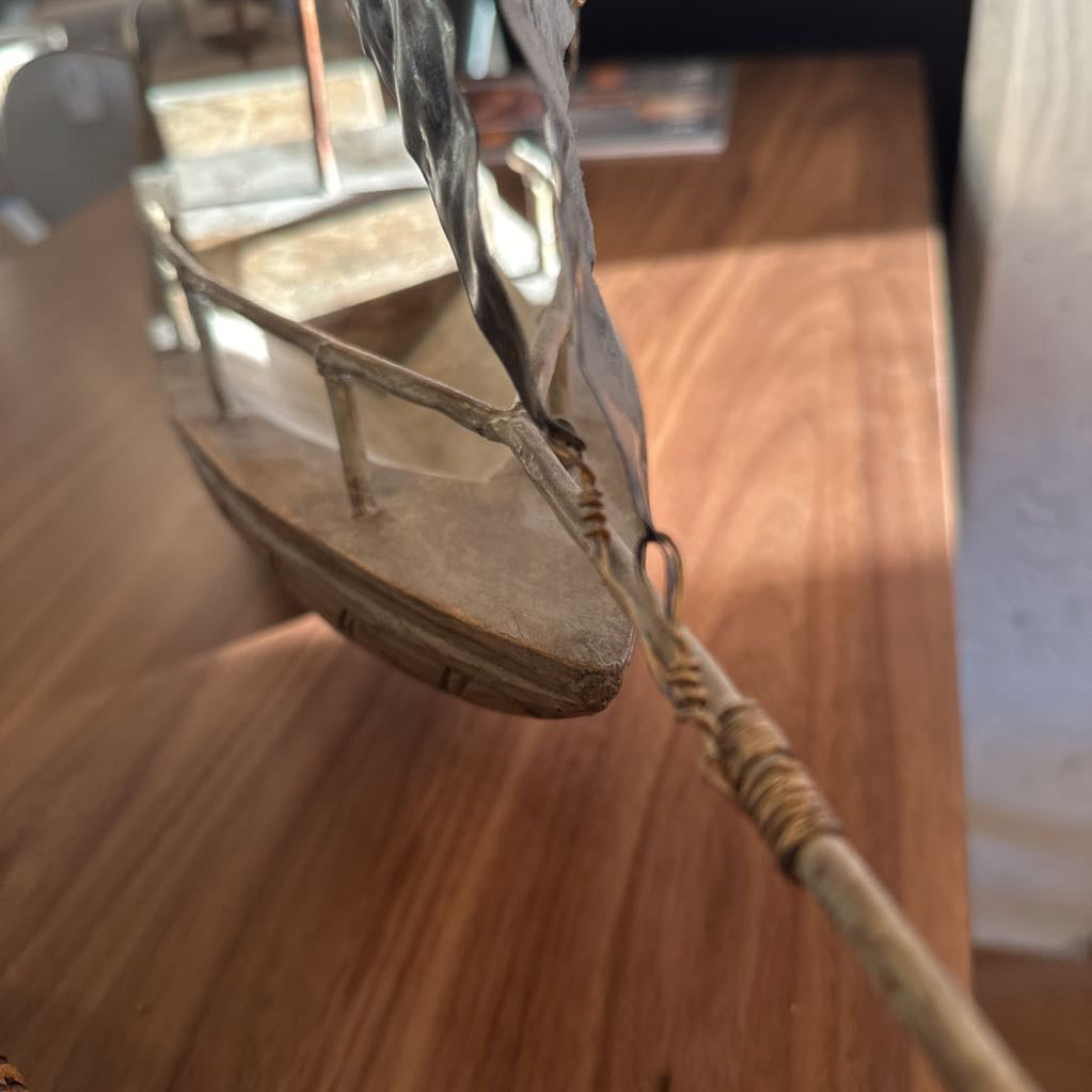 Wooden sandal with a strap on a wooden floor