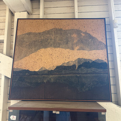 Large abstract painting on a wooden shelf against a light-colored wall.