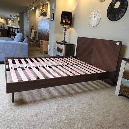 Wooden staircase with striped railing in a home interior setting