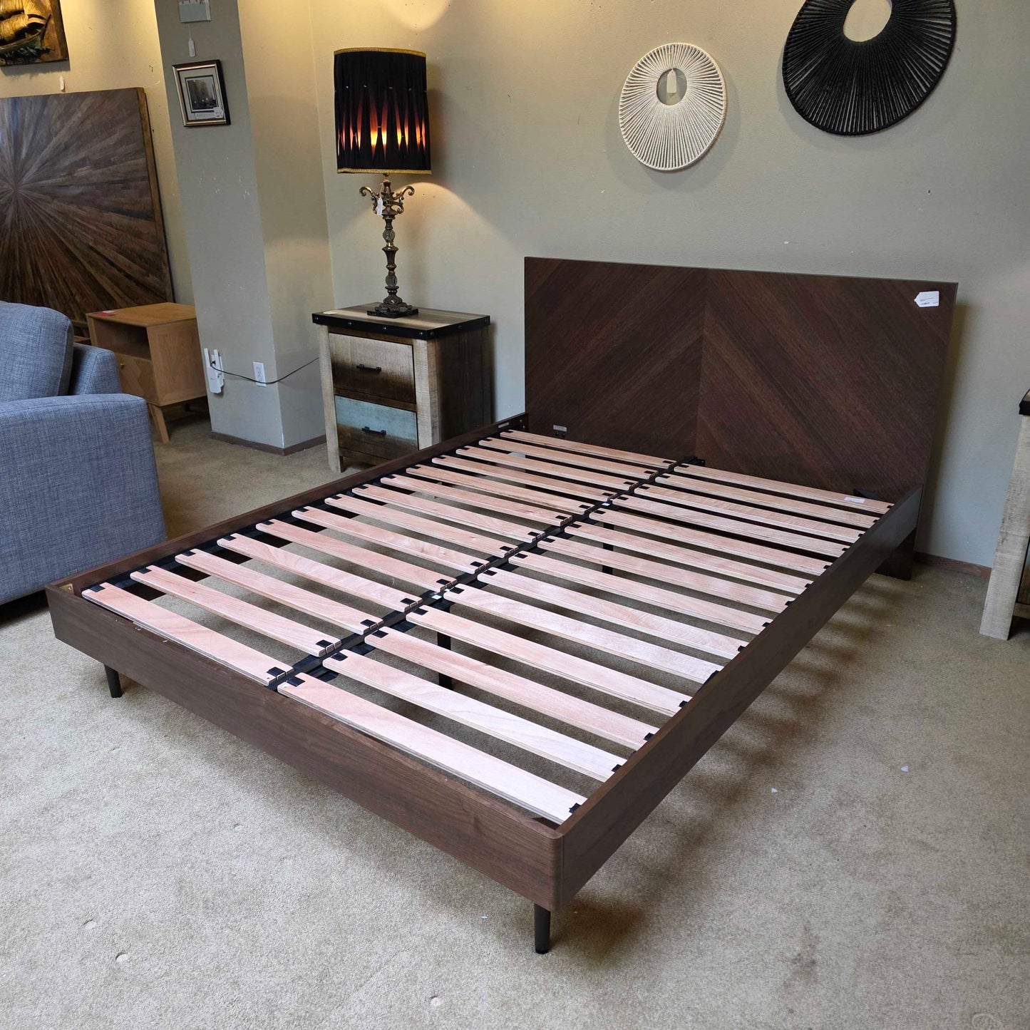 Wooden bed frame with slats in a room setting