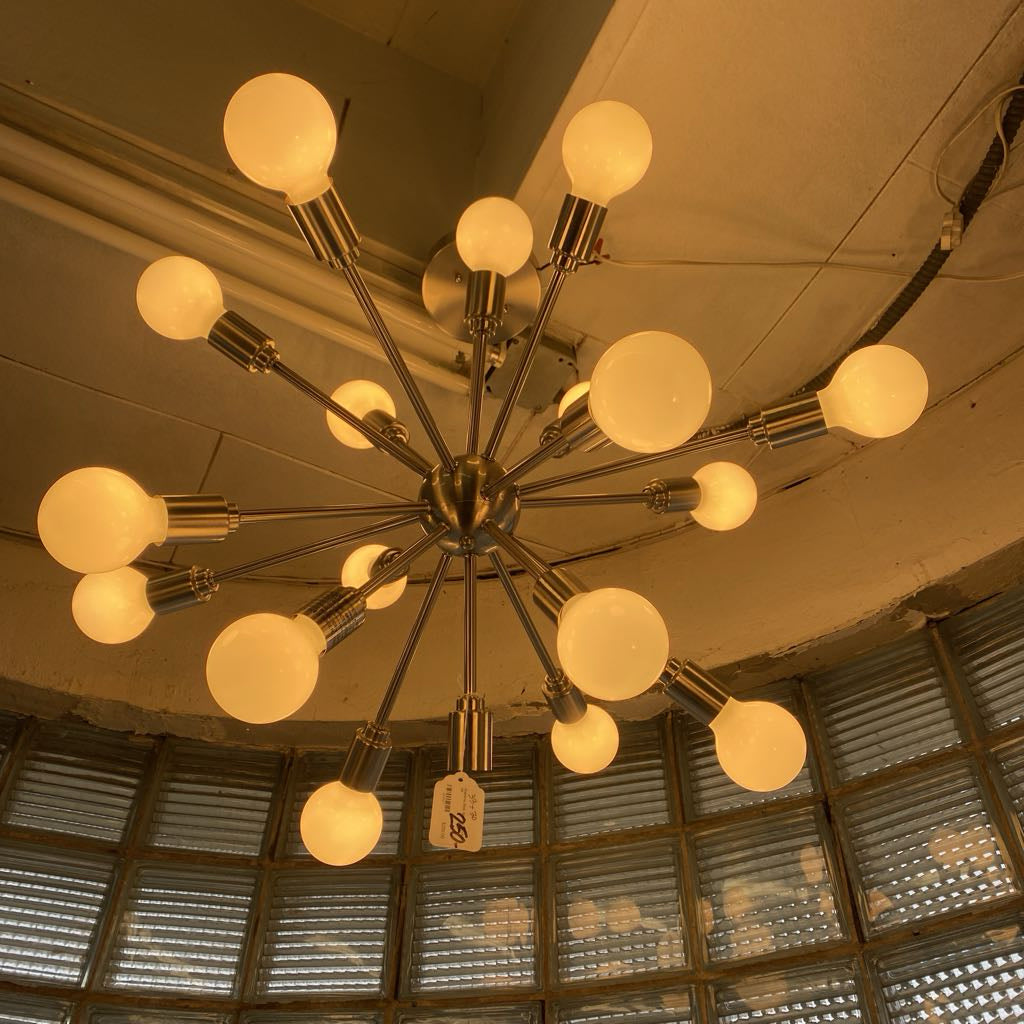 Chandelier with multiple light bulbs hanging from a ceiling