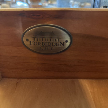 Wooden box with 'Forbidden City' logo on a wooden surface