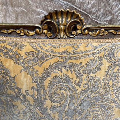 Decorative gold and silver patterned fabric with intricate design