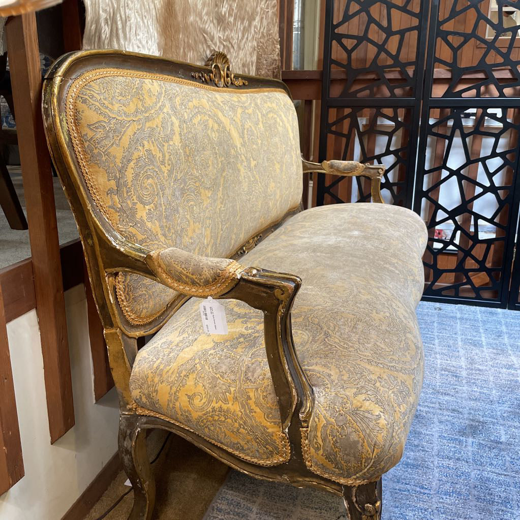 Decorative armchair with gold and gray pattern in a room setting