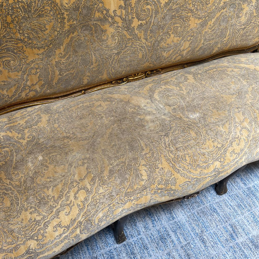 Patterned upholstered chair on a blue carpet