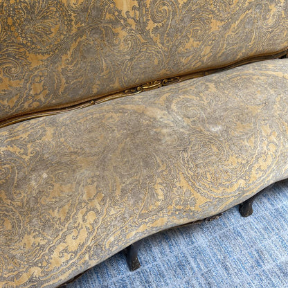 Patterned upholstered chair on a blue carpet