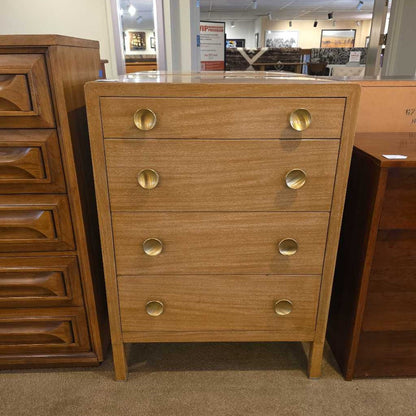 Wooden dresser with gold knobs in a store setting