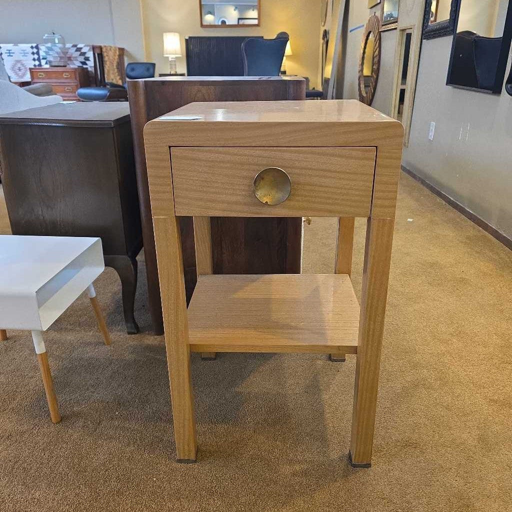 Wooden side table with a drawer in a furniture store setting