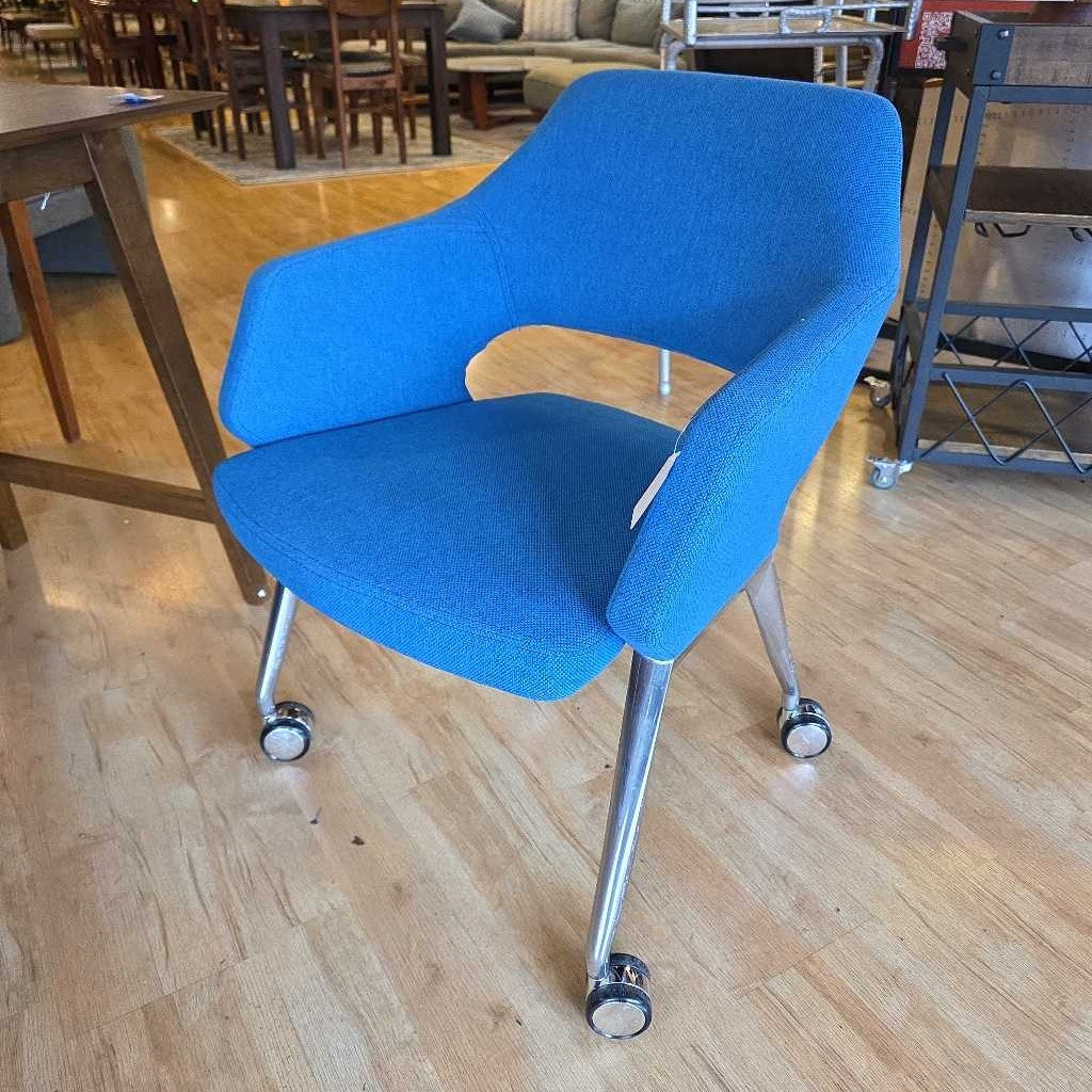 Blue office chair with wheels on a wooden floor