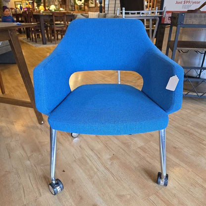 Blue chair with wheels on a wooden floor in an indoor setting