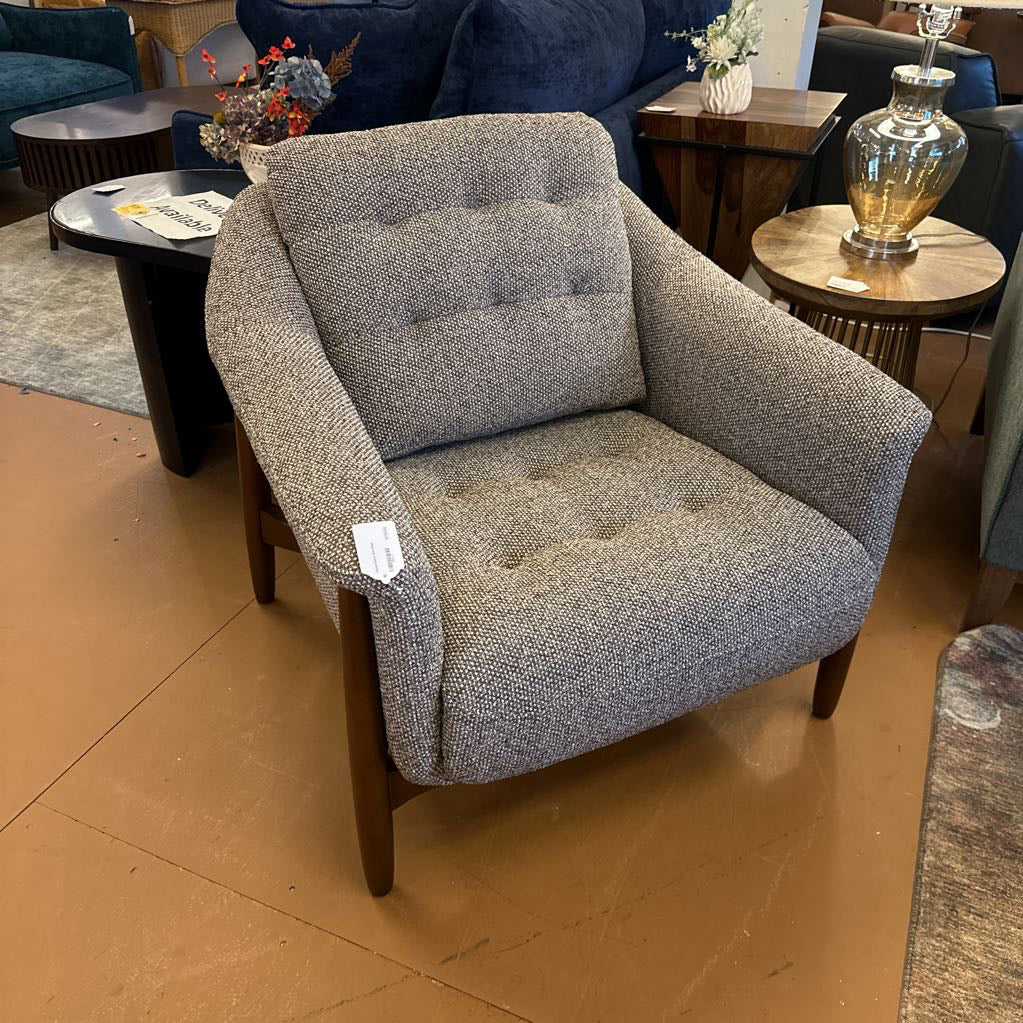 Gray armchair with a price tag in a showroom setting