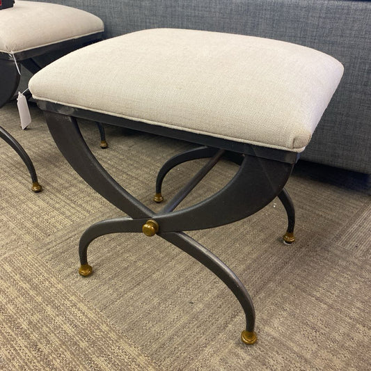 Decorative stool with a cushioned seat on a carpeted floor