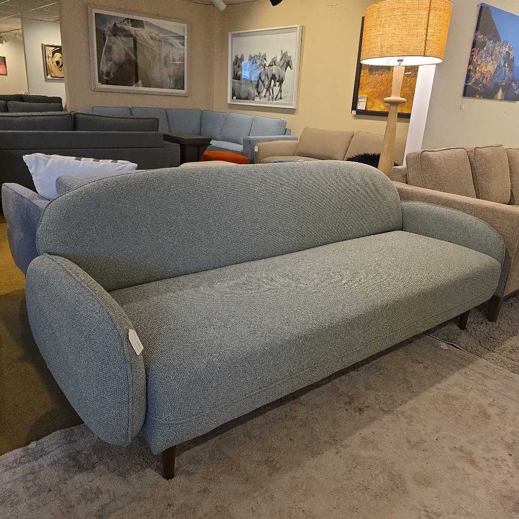 Gray sofa in a room with other furniture and decor