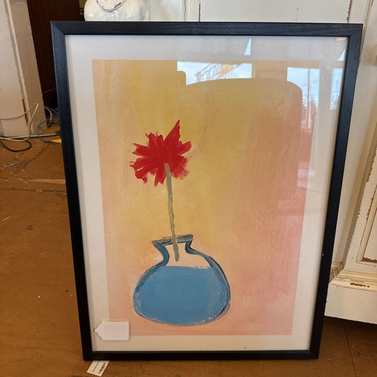 Framed artwork of a red flower in a blue vase on a yellow background