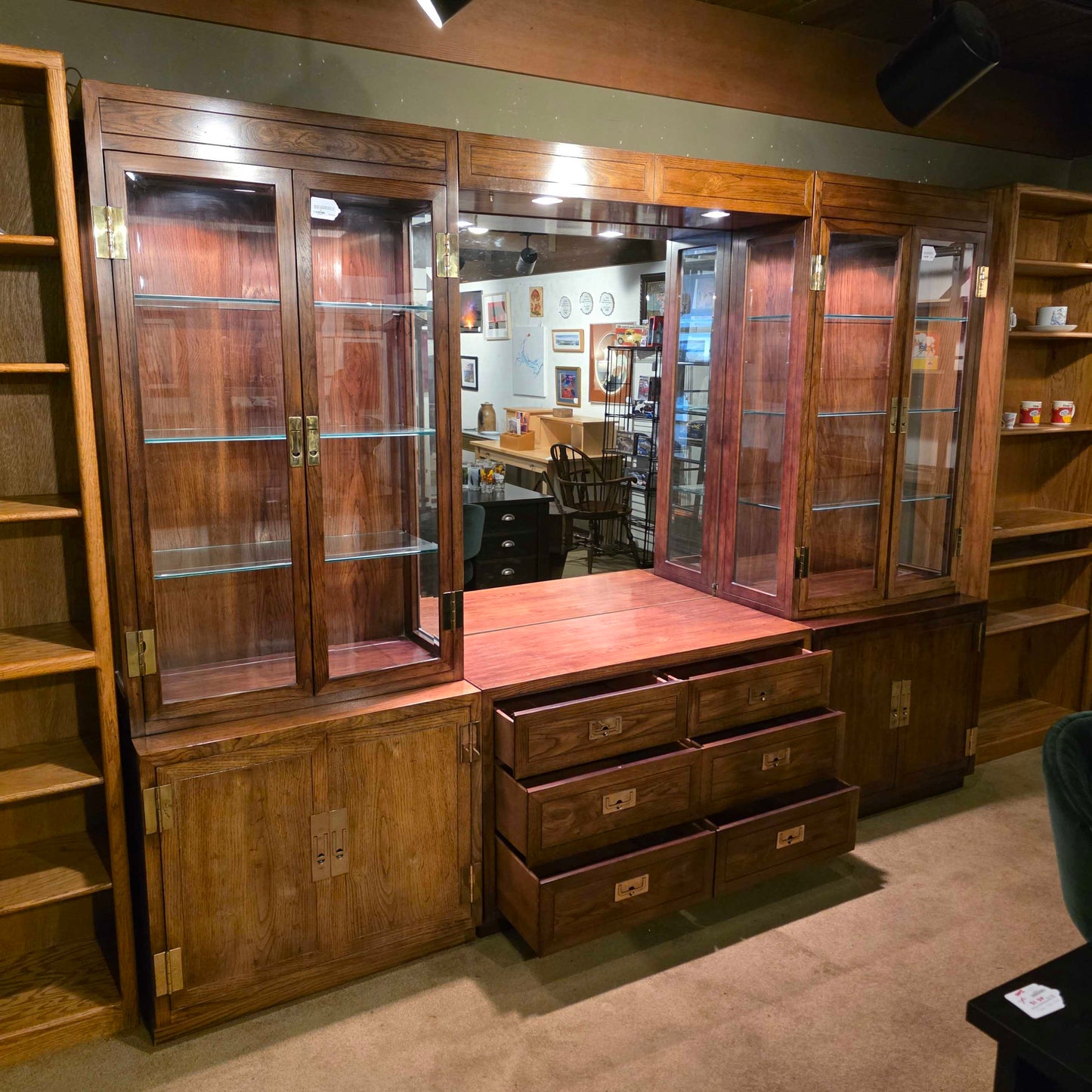 Wooden display cases with glass panels on a floor.