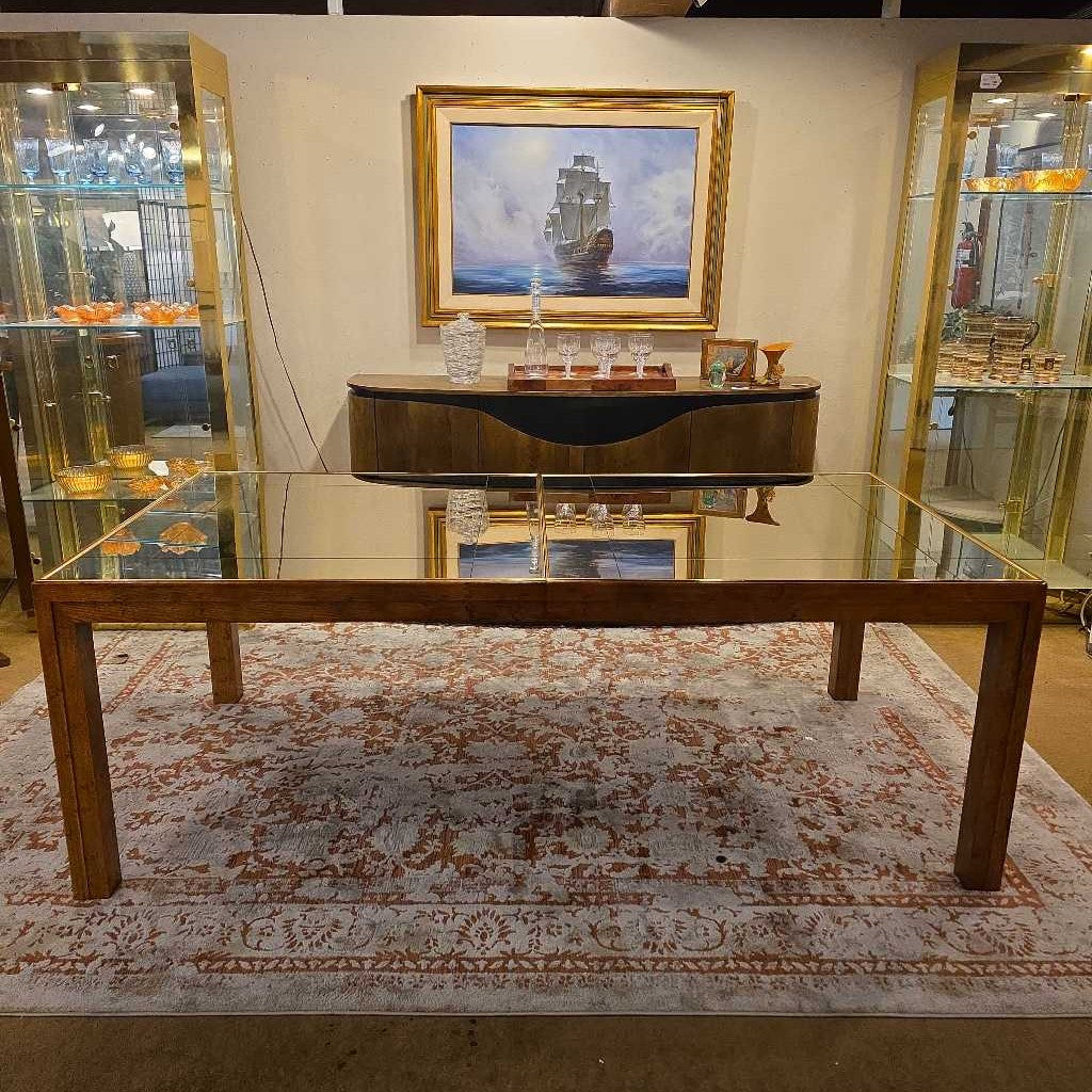 Wooden coffee table in a room with a painting on the wall and decorative items.