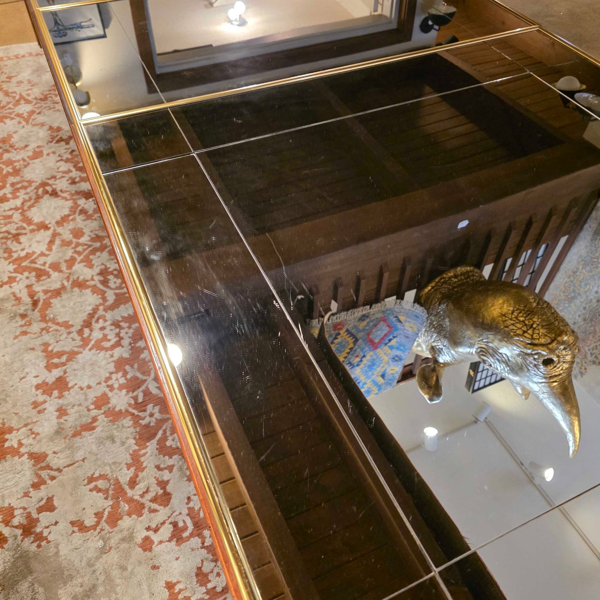 Taxidermy bird on a tiled wall with a decorative mirror
