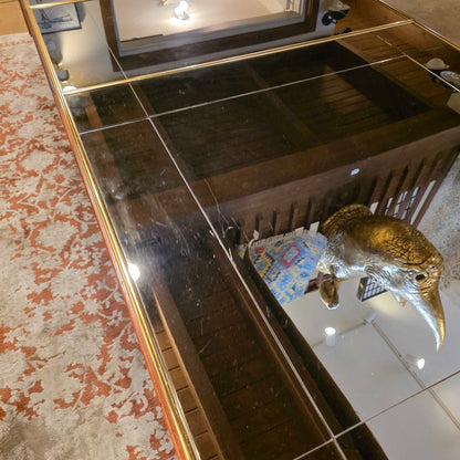 Taxidermy bird on a tiled wall with a decorative mirror