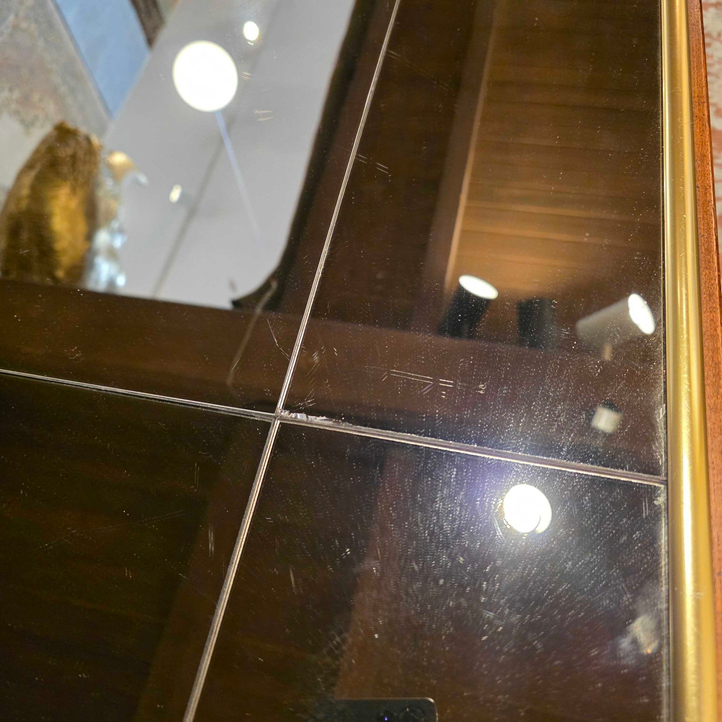 Scratched surface of a mirror with reflections of lights