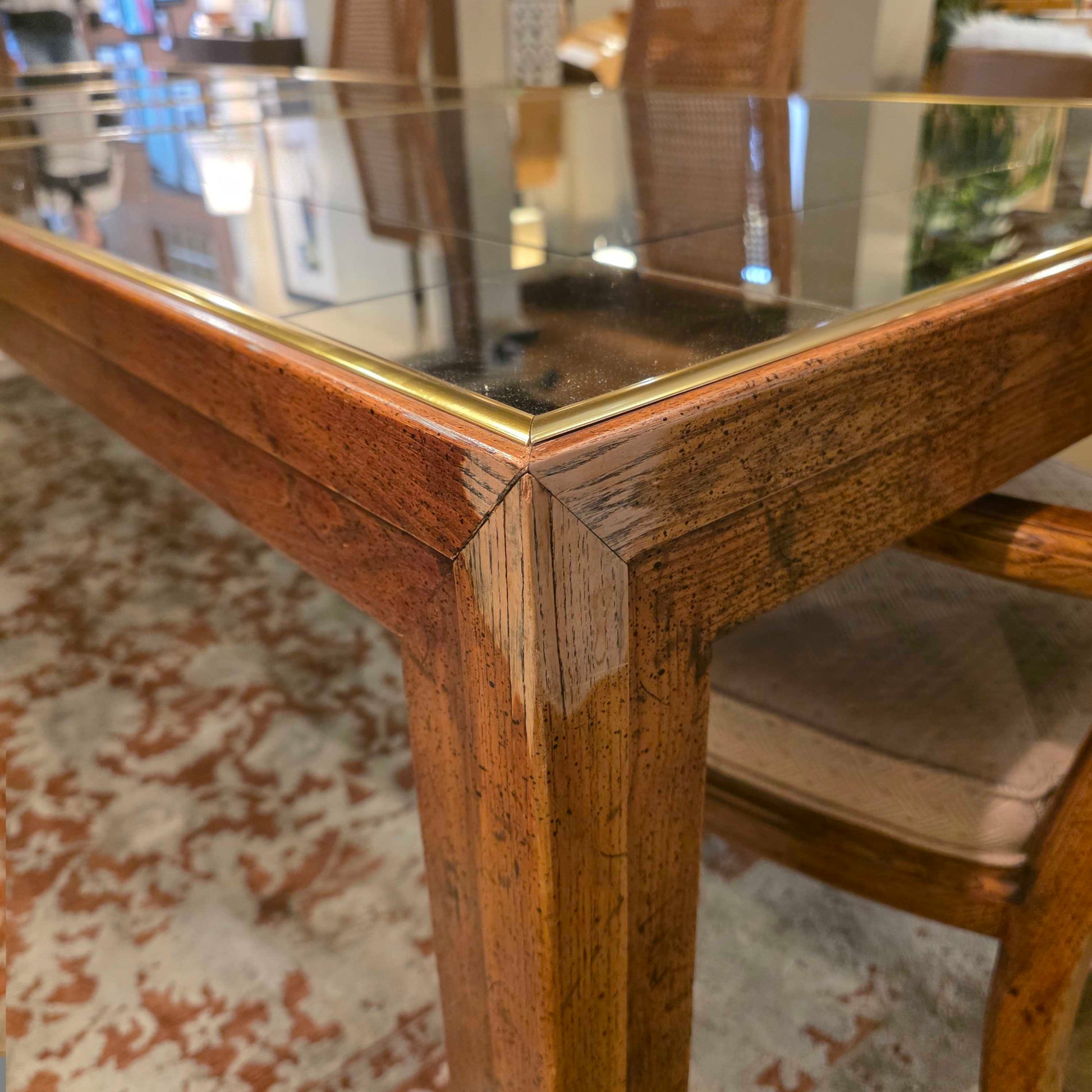 Close-up of a wooden chair with a gold frame in an indoor setting.