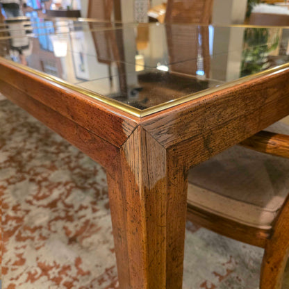 Close-up of a wooden chair with a gold frame in an indoor setting.