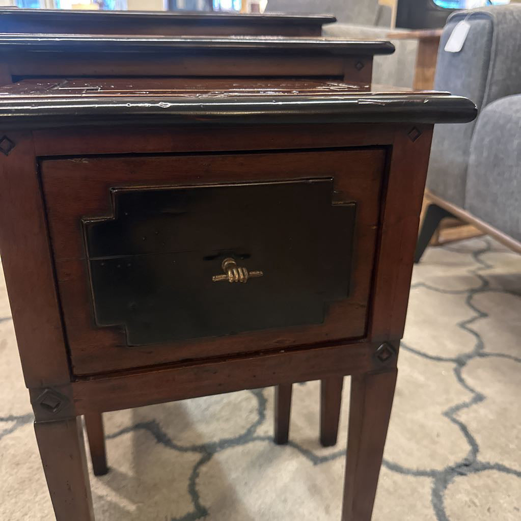 Wooden side table with a drawer on a patterned carpet