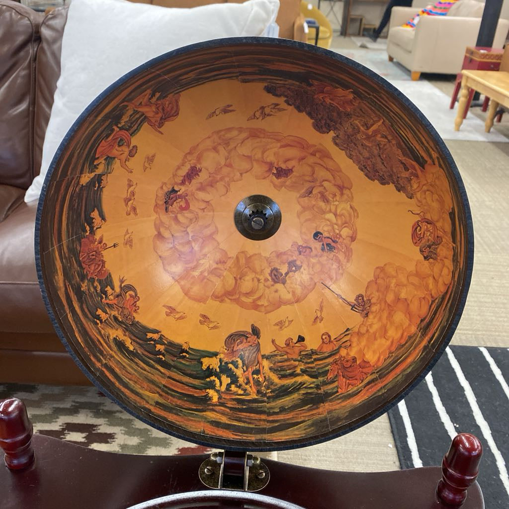 Decorative circular object with artistic design on a table in a living room setting