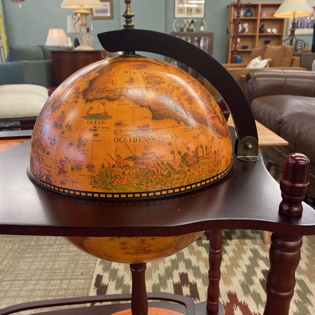 Vintage-style world globe on a wooden stand in a living room setting