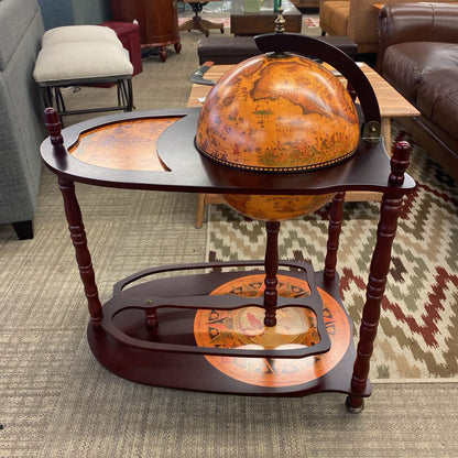 Decorative globe on a wooden stand in a living room setting