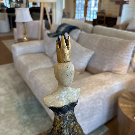 Decorative sculpture with a gold crown in a living room setting