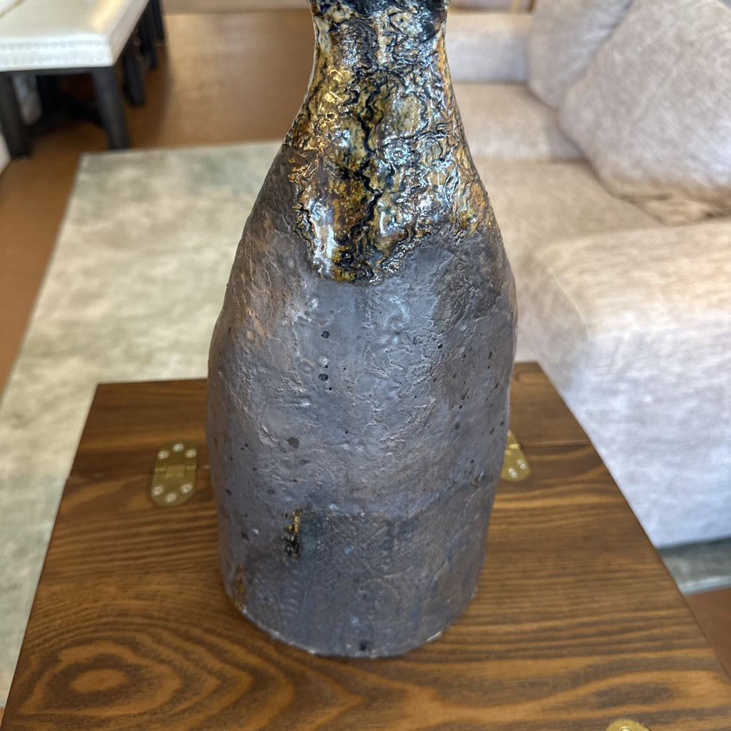 Decorative bottle on a wooden table with a blurred background