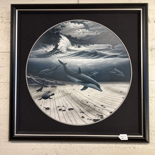 Framed artwork of dolphins in a coastal scene with waves and birds.