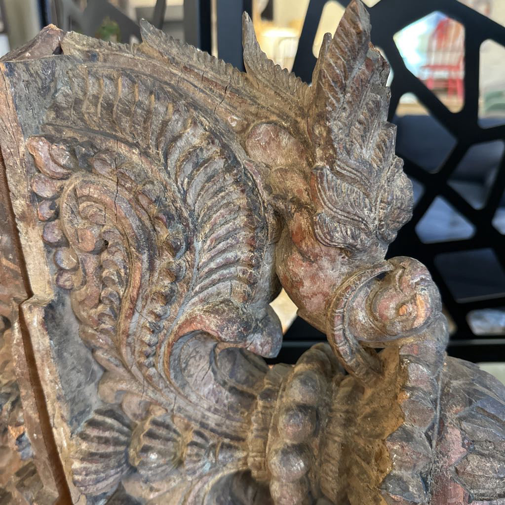 Decorative stone sculpture with intricate carvings on a blurred background