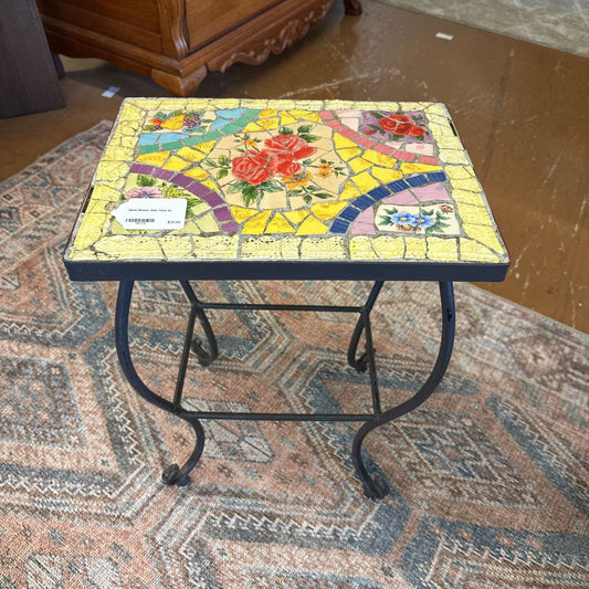 Mosaic table with floral design on a patterned rug