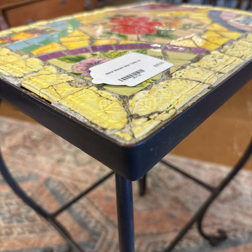 Mosaic-topped table with a colorful design on a blurred background