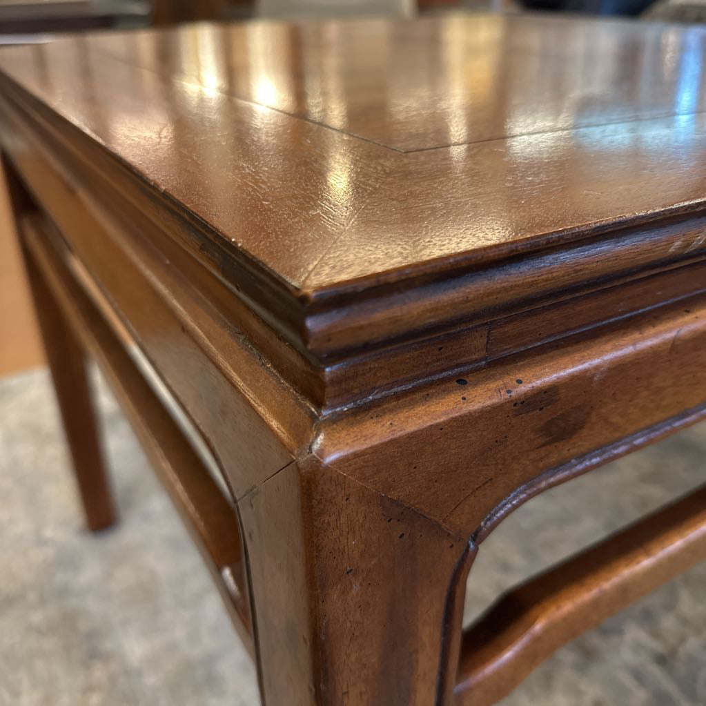 Close-up of a wooden chair with a worn surface