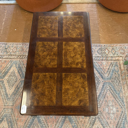 Wooden tray with a checkered pattern on a textured surface