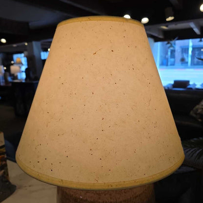 Beige lampshade with a blurred indoor background