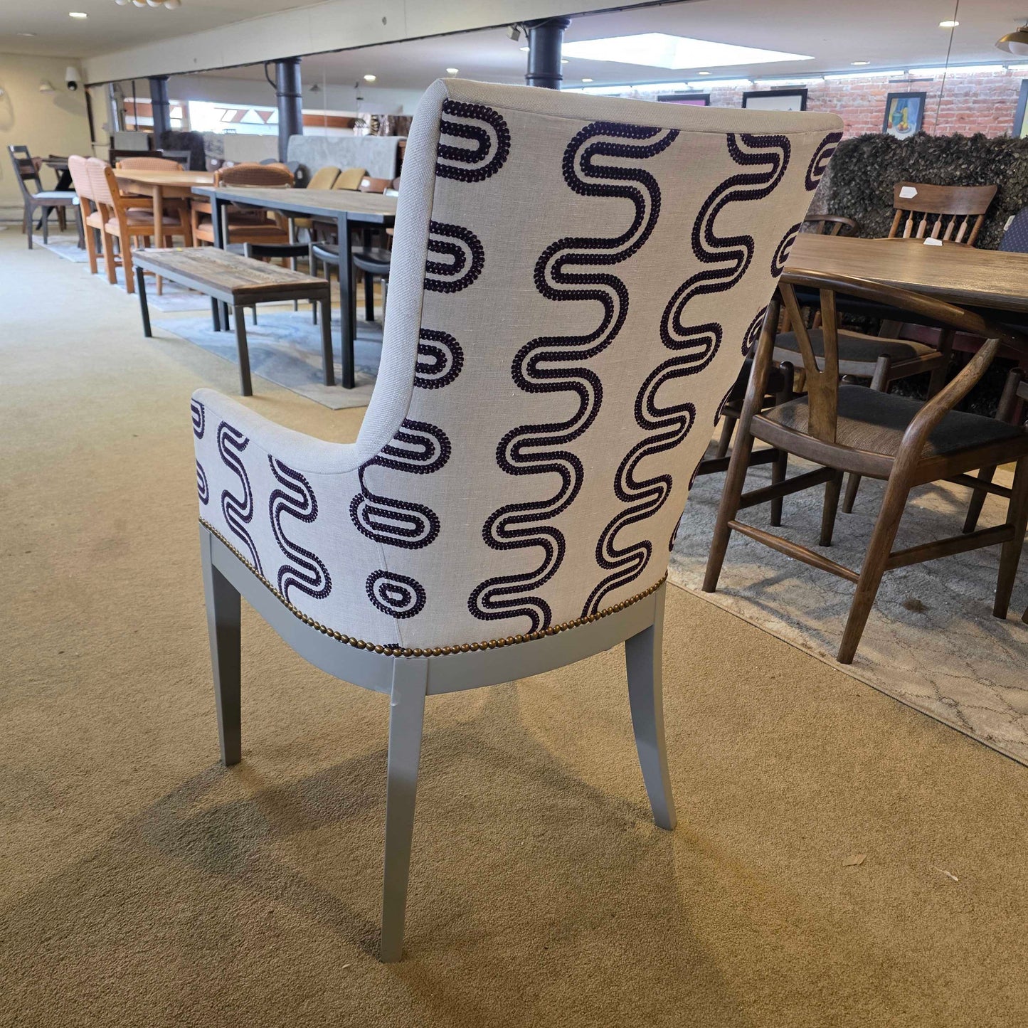 Chair with a black wavy pattern on a beige carpet