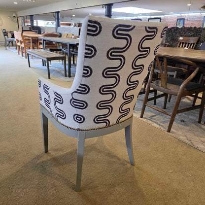 Chair with a black wavy pattern on a beige carpet