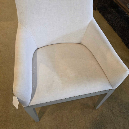 Beige lounge chair on a brown carpet