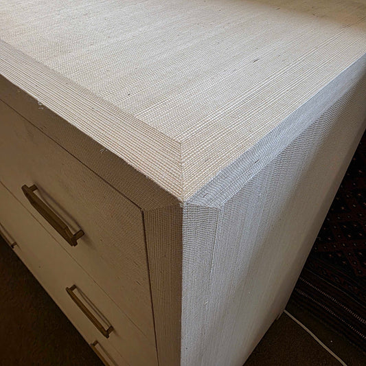 Close-up of a textured surface with a corner and a cabinet handle.