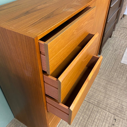 Wooden dresser with open drawers on a carpeted floor