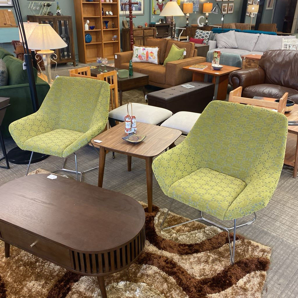 Living room with green chairs, wooden coffee table, and various furniture pieces.